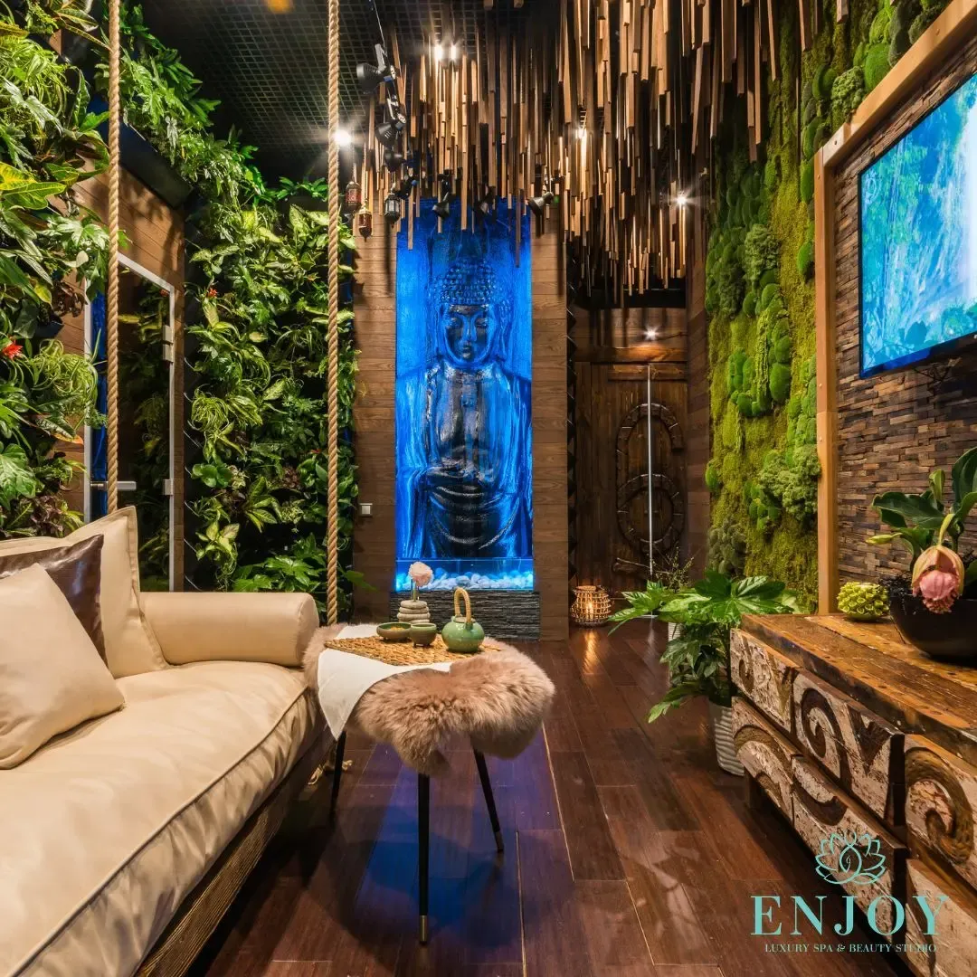 Massage room with a green wall and a Buddha — Enjoy Spa, Moscow