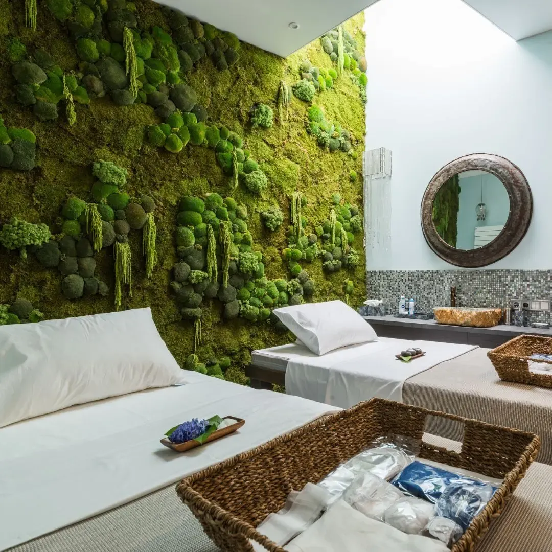 Green moss wall in a massage room — Enjoy Spa